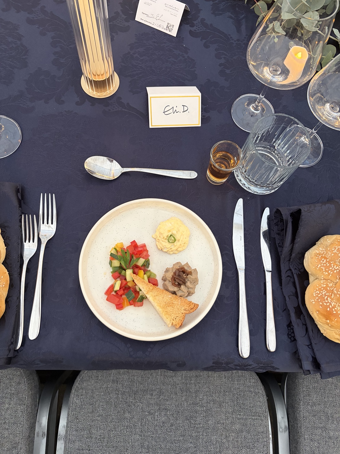 Close-up of a formal place setting and plated dish